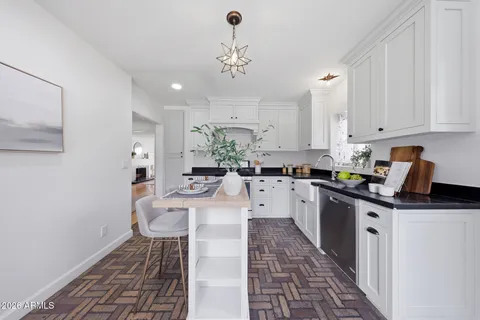 a kitchen with stainless steel appliances kitchen island granite countertop a sink and cabinets