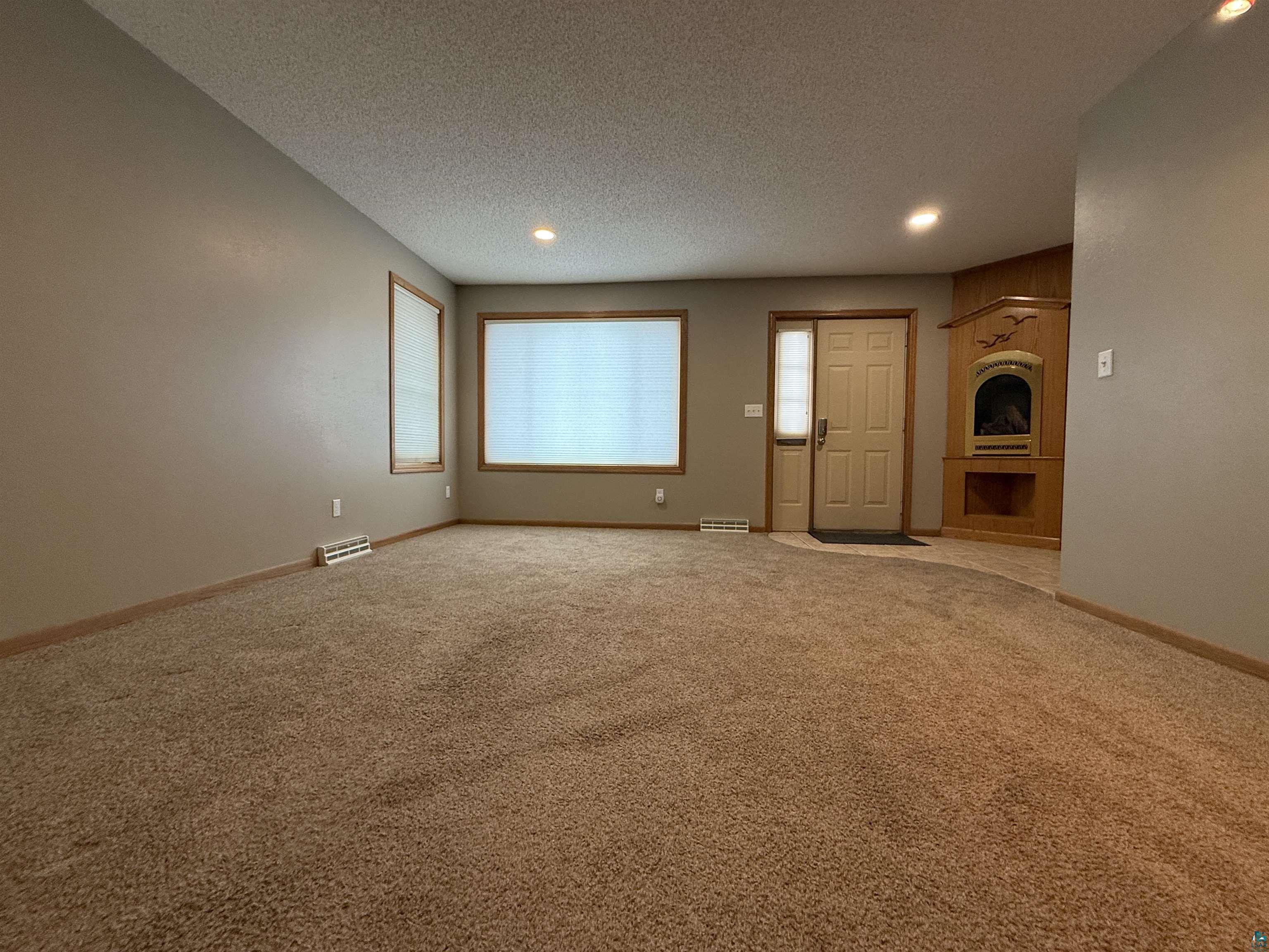1321 South 13th Street Virginia, MN 55792 - Photo 11 of 33 Unfurnished living room featuring recessed lighting, carpet floors, and a textured ceiling