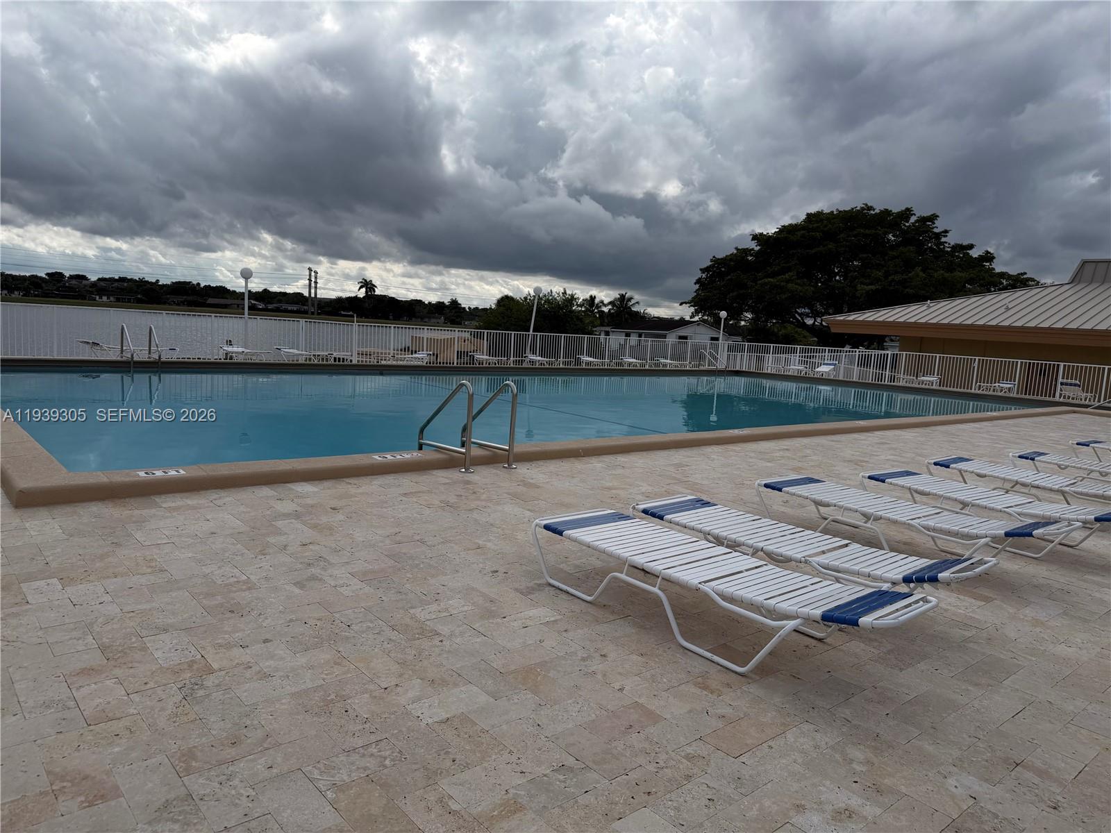 8111 Southwest 129th Avenue Miami, FL 33183 - Photo 18 of 20 a view of a swimming pool with outdoor seating and yard