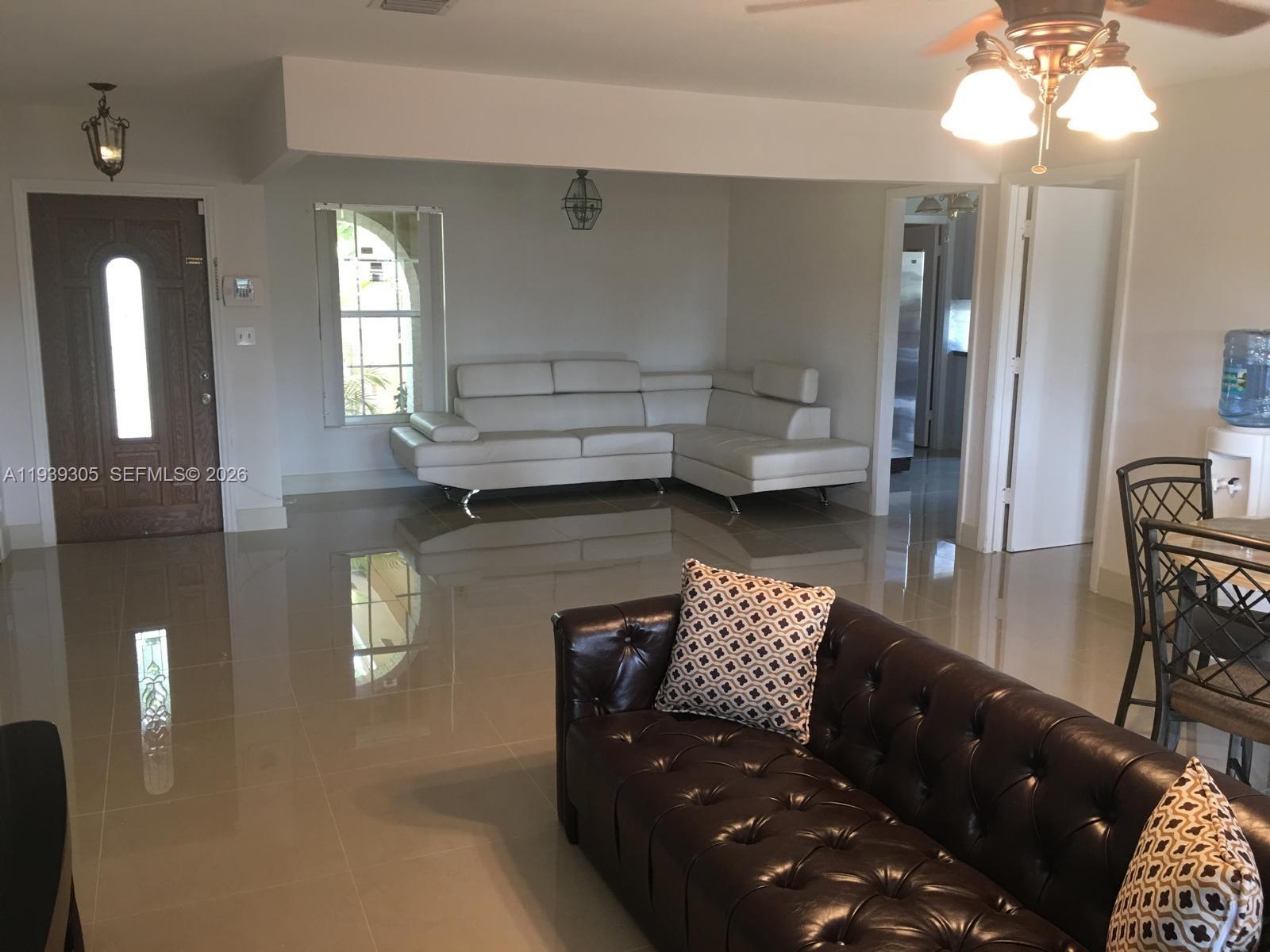 8111 Southwest 129th Avenue Miami, FL 33183 - Photo 2 of 20 a living room with furniture and a chandelier