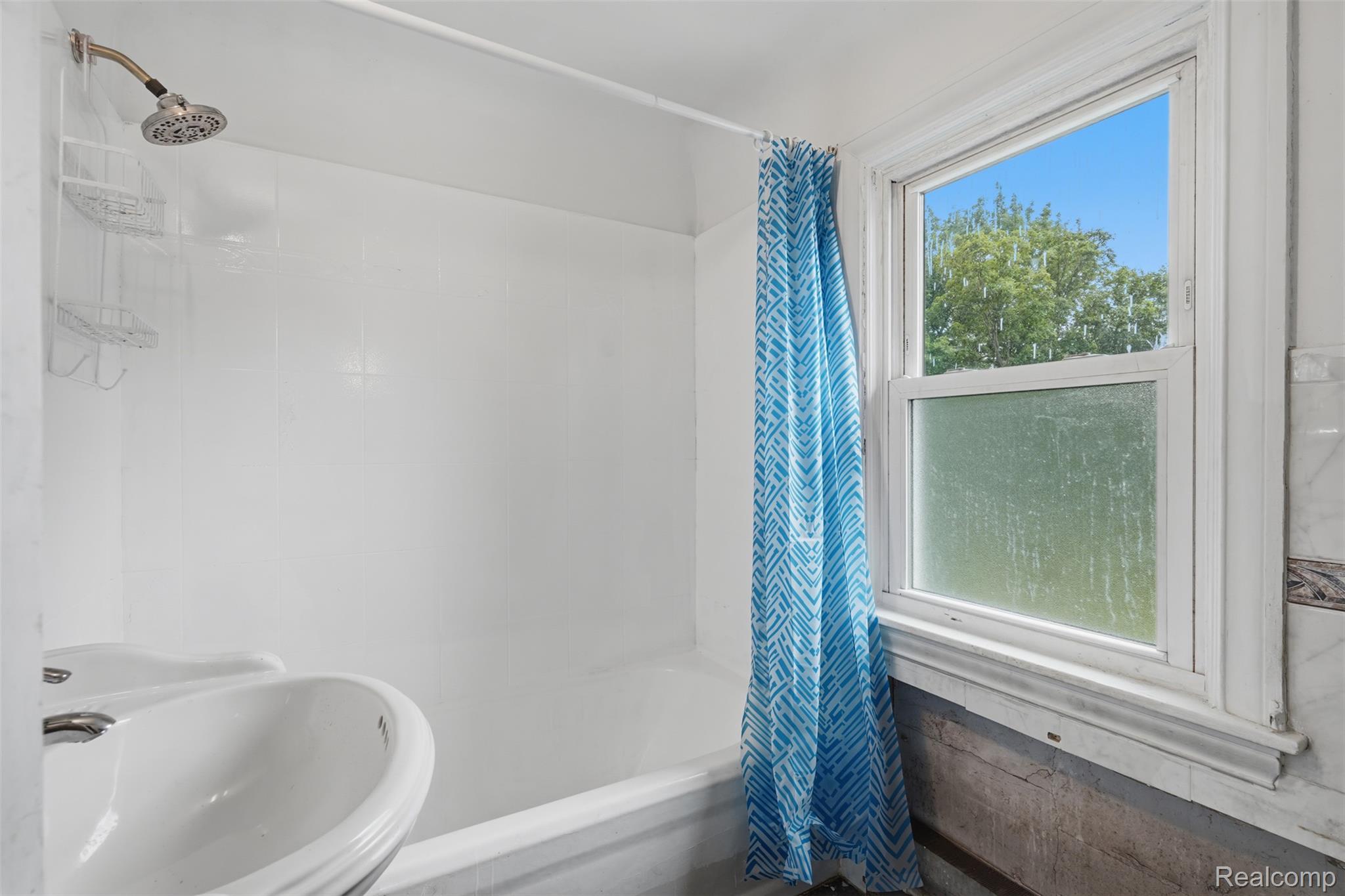 31000 Drake Road Farmington, MI 48331 - Photo 21 of 44 Bathroom featuring a shower/tub combination with white surround, a pedestal sink, and a window with frosted lower pane