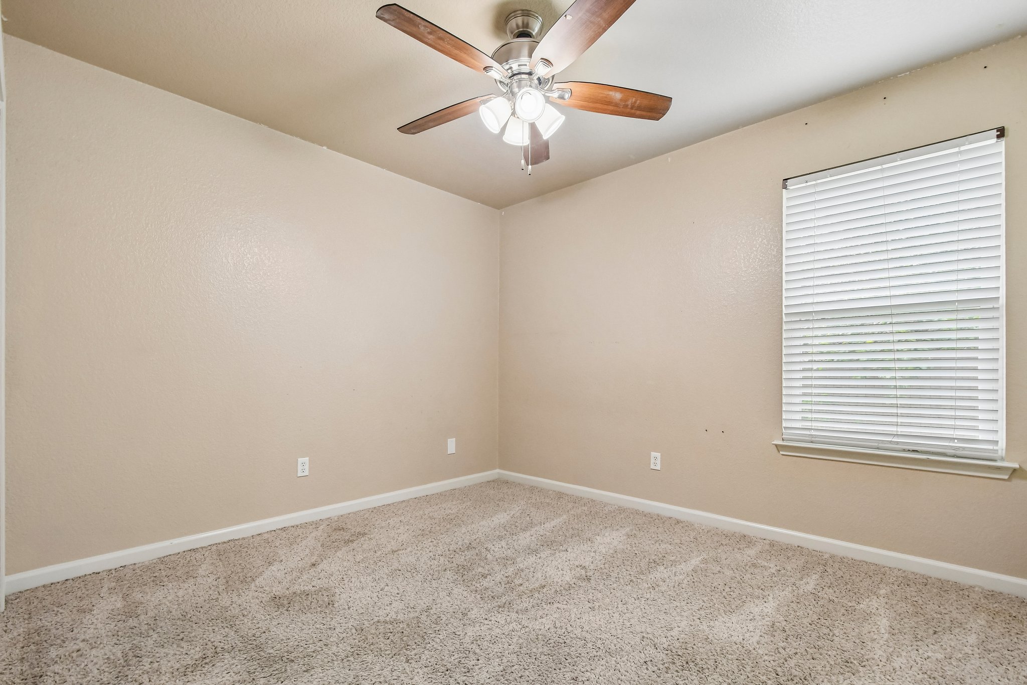 125 Mason Reed Cove Kyle, TX 78640 - Photo 24 of 39 an empty room with a window and a fan