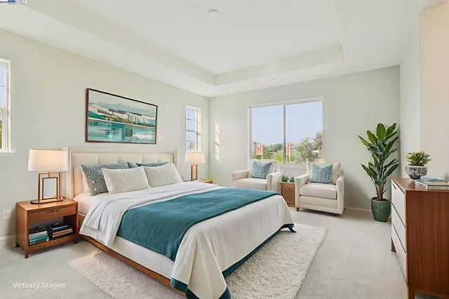 a bedroom with a large bed and a couch