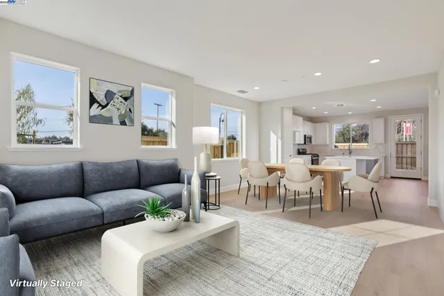 a living room with furniture kitchen view and a dining table