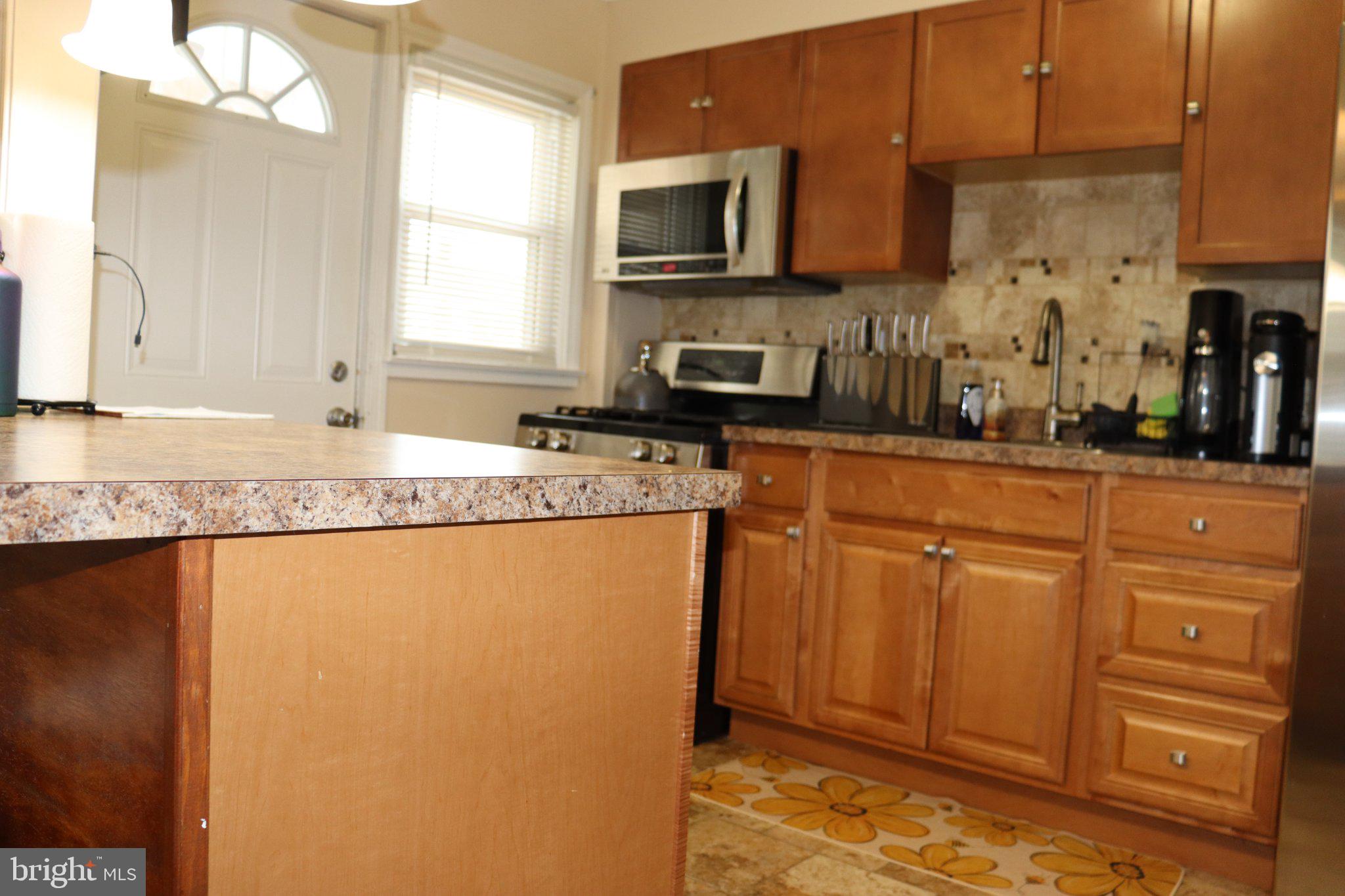 1328 Cedarcroft Road Baltimore, MD 21239 - Photo 27 of 39 Modern kitchen with warm wood tones.