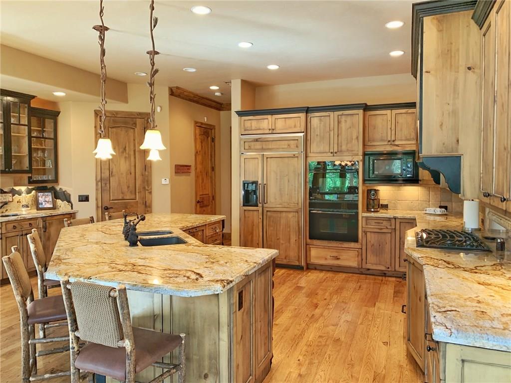 79 Rounds Road Breckenridge, CO 80424 - Photo 9 of 11 a kitchen with stainless steel appliances granite countertop sink stove and refrigerator