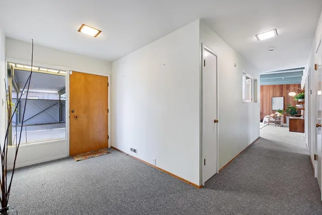 a view of hallway with stairs and wooden floor