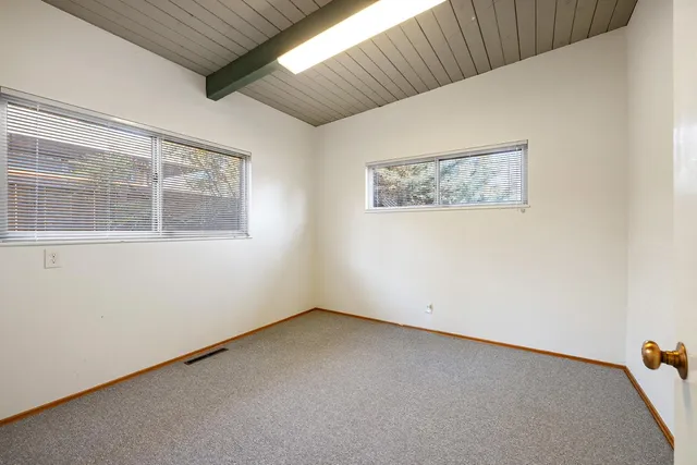 a view of a livingroom with entryway and white walls