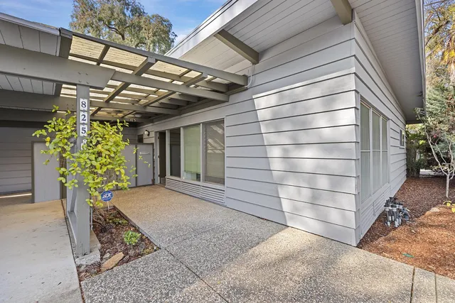 a view of garage with a large tree