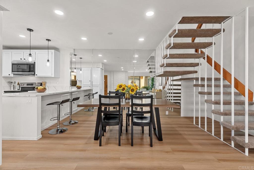 a view of a kitchen with dining room and wooden floor