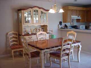 110 North Delaware Boulevard Jupiter, FL 33458 - Photo 2 of 5 a view of a dining room with furniture and a chandelier