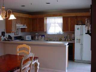 110 North Delaware Boulevard Jupiter, FL 33458 - Photo 3 of 5 a kitchen with a refrigerator a stove a sink and cabinets