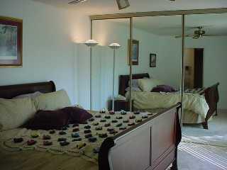 110 North Delaware Boulevard Jupiter, FL 33458 - Photo 4 of 5 a bedroom with a bed and a mirror on the dresser