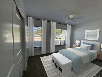 a bedroom with a large bed and a chandelier