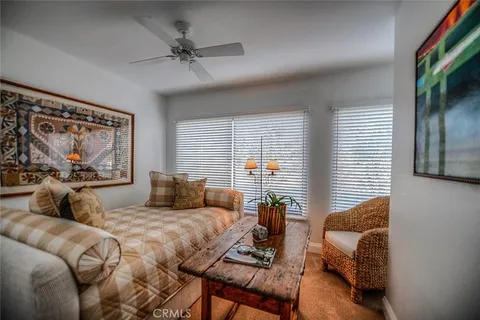 a bedroom with a bed a couch and a window