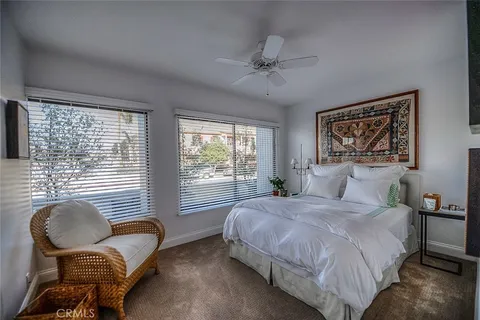 a bedroom with a bed chairs and window