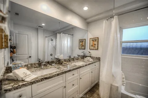 a bathroom with double sink and a mirror