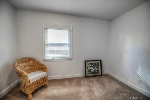 a living room with a window and a chair