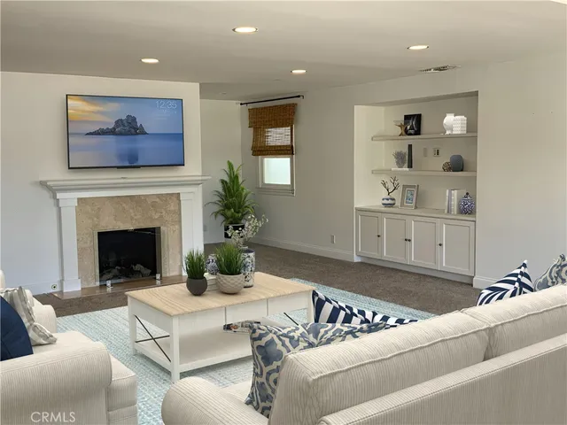 a living room with furniture and a fireplace