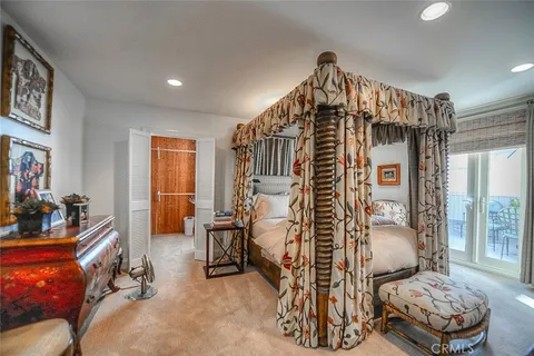 a bedroom with furniture and a chandelier