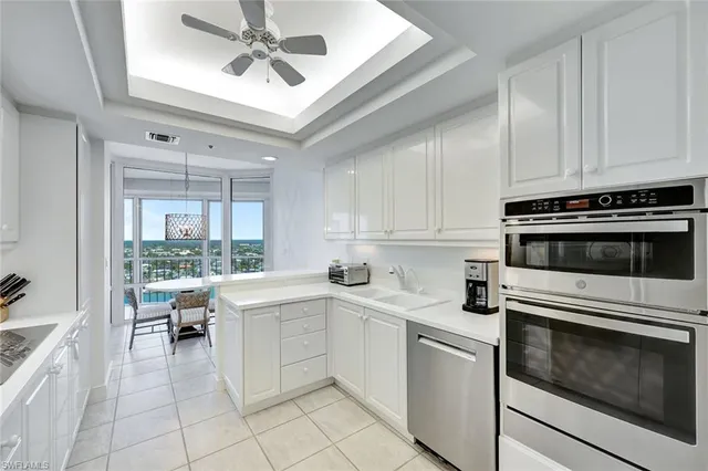 a kitchen with a stove oven and white cabinets