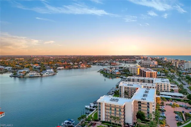 an aerial view of a city with ocean view