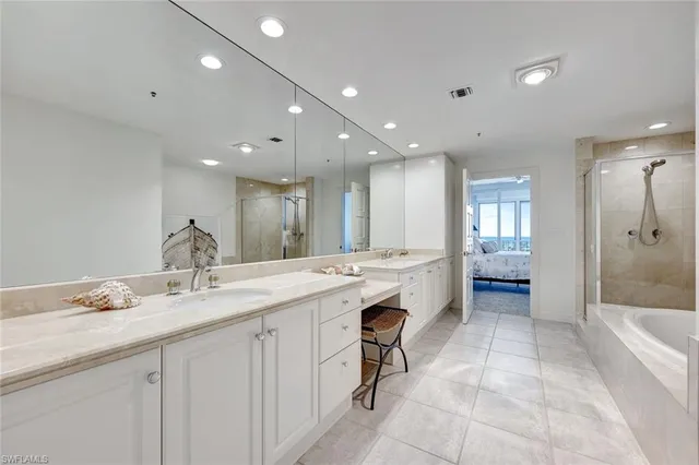 a large bathroom with a sink a large mirror and a shower