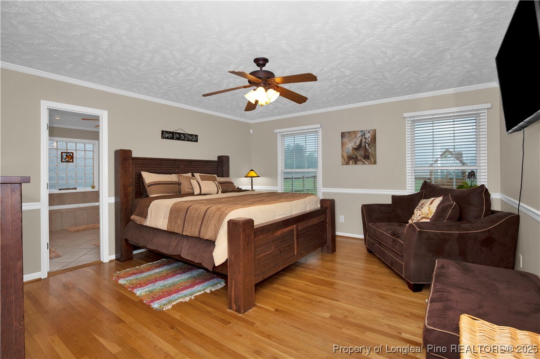 4891 Wade-Stedman Road Wade, NC 28395 - Photo 16 of 46 a bedroom with a bed and a flat screen tv