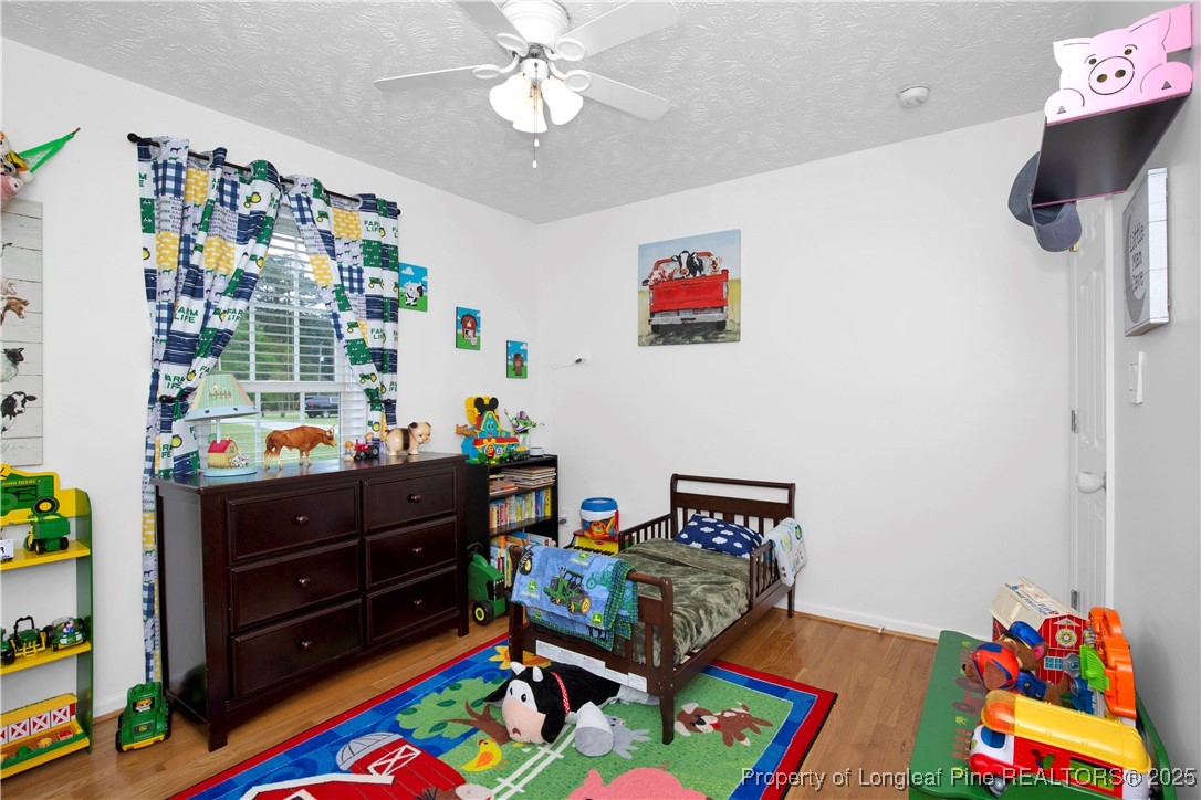 4891 Wade-Stedman Road Wade, NC 28395 - Photo 22 of 46 a bed room with furniture and a baby crib