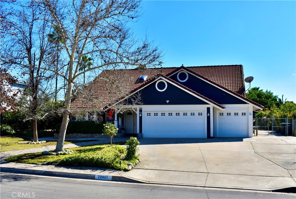 22081 Windtree Avenue Wildomar, CA 92595 - Photo 1 of 1 a front view of a house with a garden