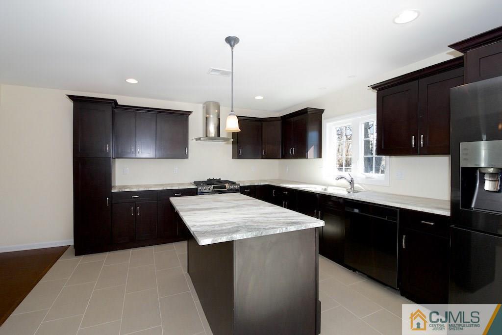 60 Ashley Road Edison, NJ 08817 - Photo 4 of 9 a kitchen with stainless steel appliances kitchen island granite countertop a sink a stove and refrigerator