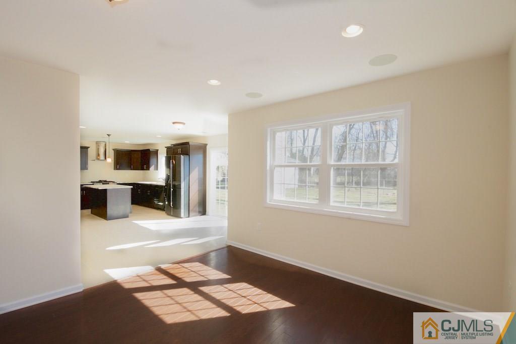 60 Ashley Road Edison, NJ 08817 - Photo 6 of 9 a view of an empty room with a window and a kitchen
