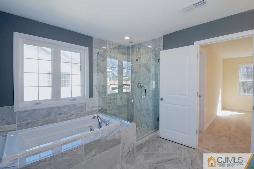 60 Ashley Road Edison, NJ 08817 - Photo 8 of 9 a bathroom with a bathtub and a shower