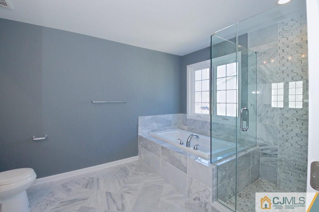 60 Ashley Road Edison, NJ 08817 - Photo 9 of 9 a bathroom with a granite countertop sink a toilet and shower
