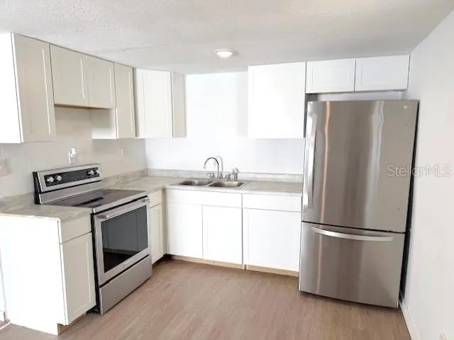 a kitchen with a refrigerator sink and microwave
