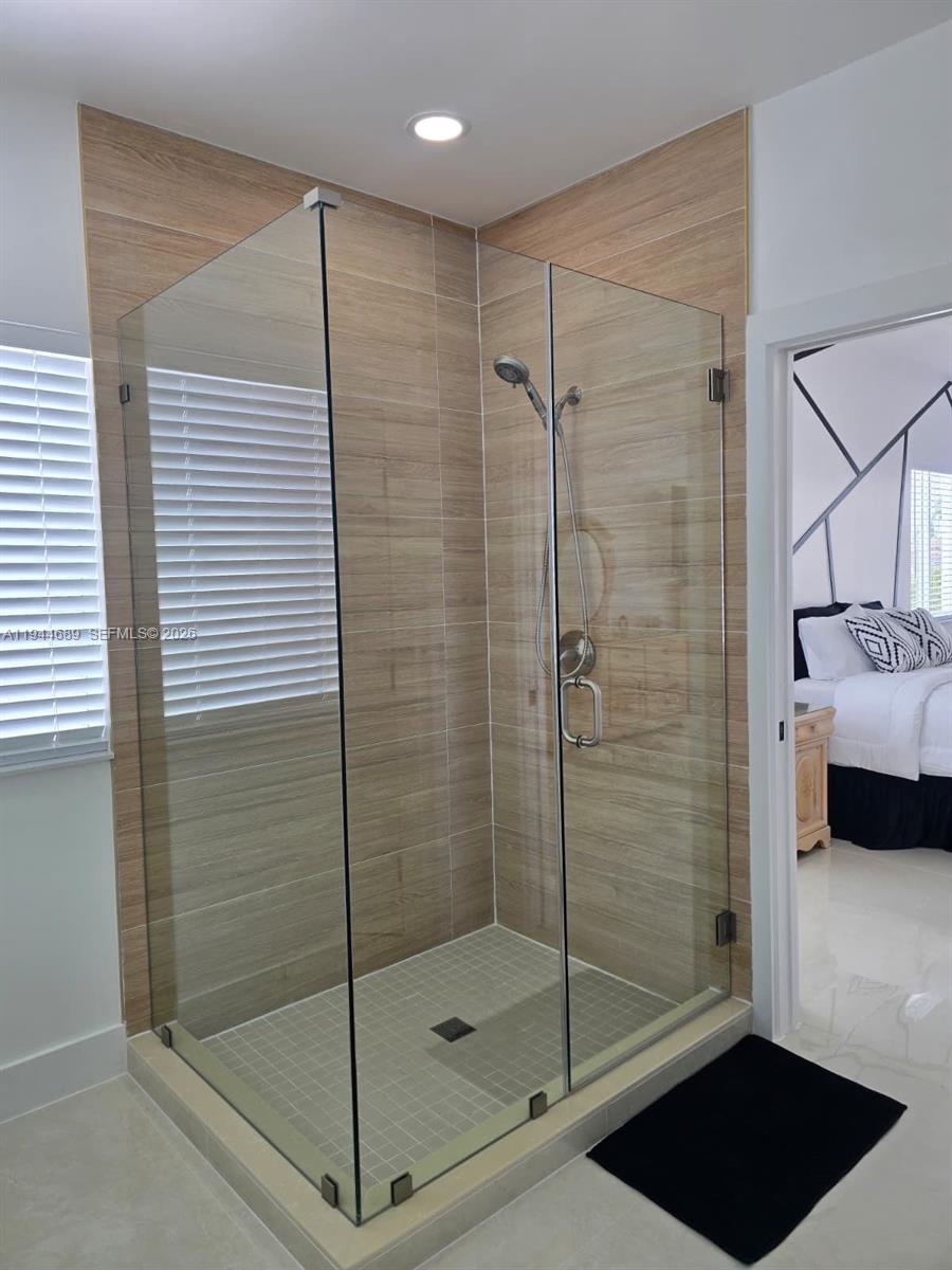 1680 Southwest 154th Path Miami, FL 33185 - Photo 15 of 100 a bathroom with a shower and a mirror