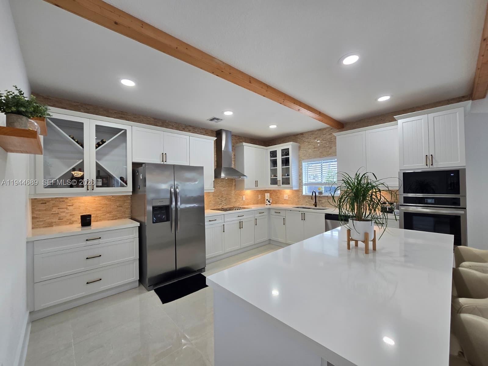 1680 Southwest 154th Path Miami, FL 33185 - Photo 22 of 100 a kitchen with stainless steel appliances kitchen island granite countertop a refrigerator and a stove top oven