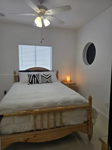 a bathroom with a granite countertop sink mirror vanity and toilet