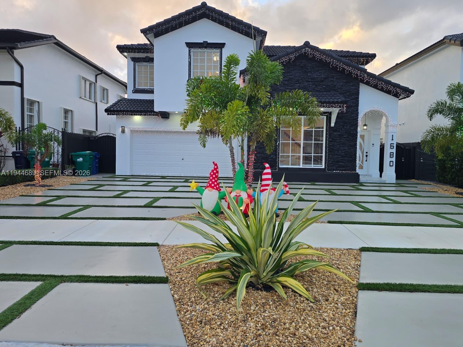 1680 Southwest 154th Path Miami, FL 33185 - Photo 39 of 100 a front view of a house with a garden