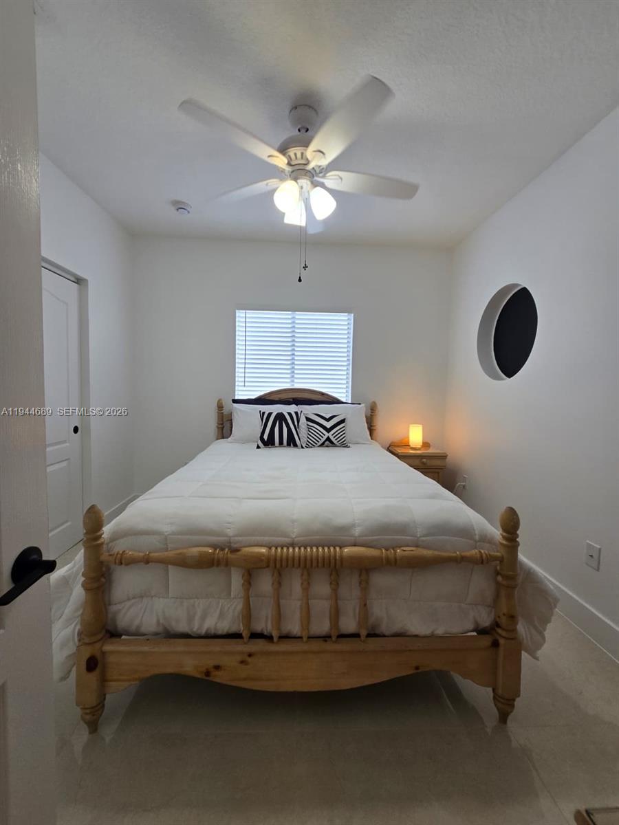 1680 Southwest 154th Path Miami, FL 33185 - Photo 52 of 100 a bedroom with a bed and a chandelier