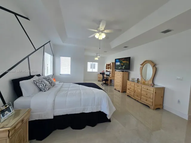 a kitchen with stainless steel appliances kitchen island granite countertop a refrigerator and a stove top oven