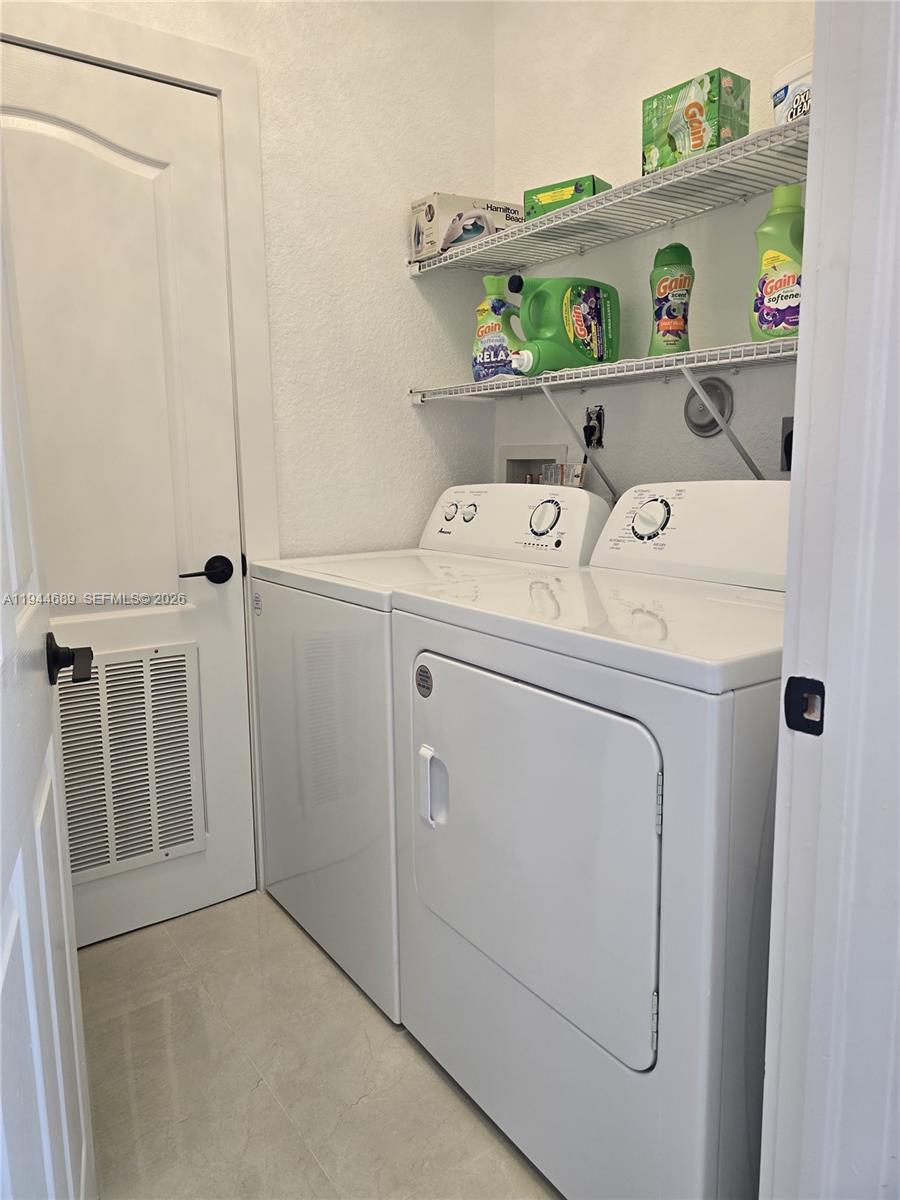 1680 Southwest 154th Path Miami, FL 33185 - Photo 86 of 100 a utility room with dryer and washer