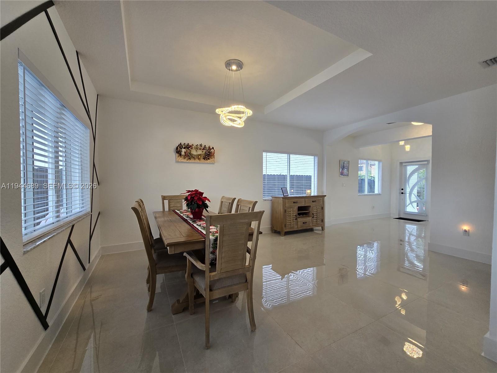 1680 Southwest 154th Path Miami, FL 33185 - Photo 93 of 100 a view of a dining room with furniture and a potted plant