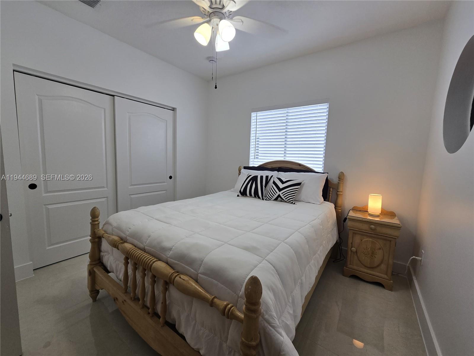 1680 Southwest 154th Path Miami, FL 33185 - Photo 99 of 100 a bedroom with a bed and a chandelier