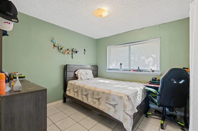 a bedroom with a bed and a table in it