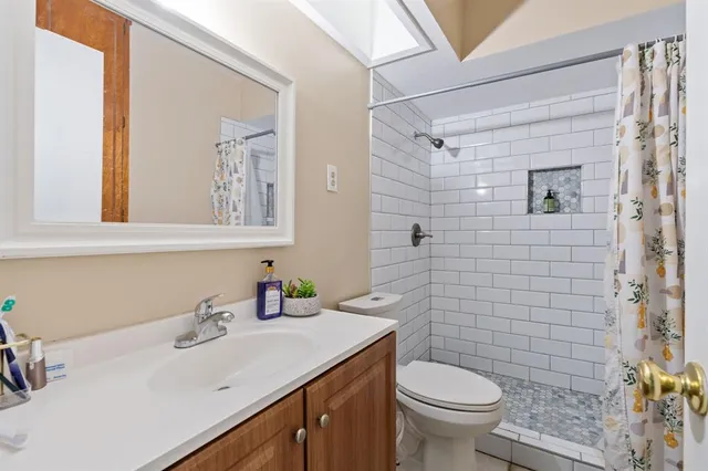 a bathroom with a sink toilet and shower