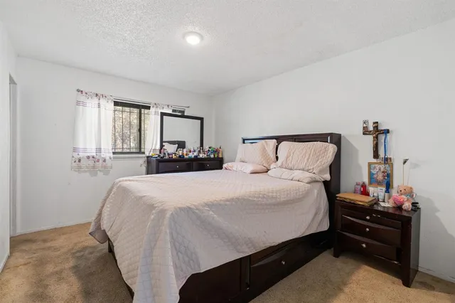 a bedroom with a bed and a window