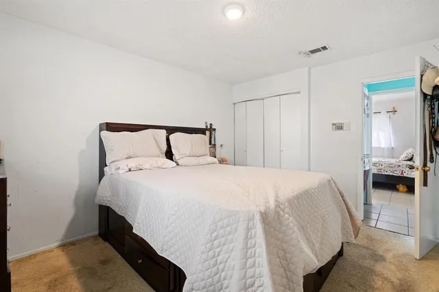 a bedroom with a bed and a dresser