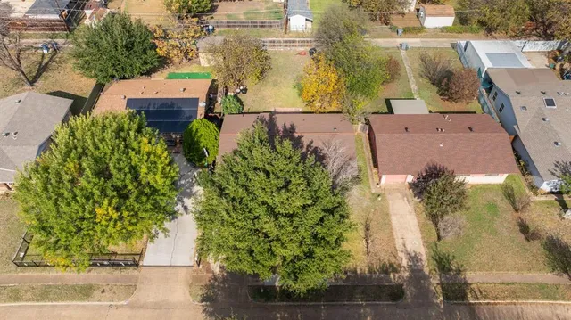 an aerial view of a house with a yard basket ball court and outdoor seating