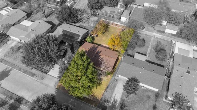 an aerial view of a house with a yard and a yard